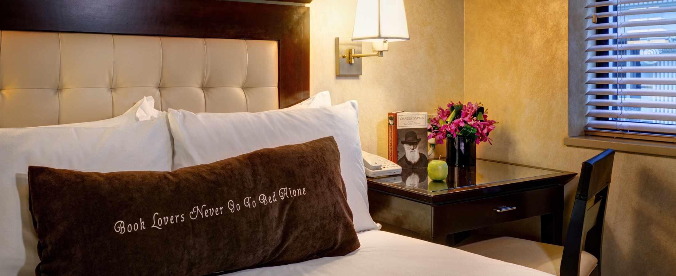 Signature Pillow at Library Hotel quoting "Book Lovers Never Go to Bed Alone"
