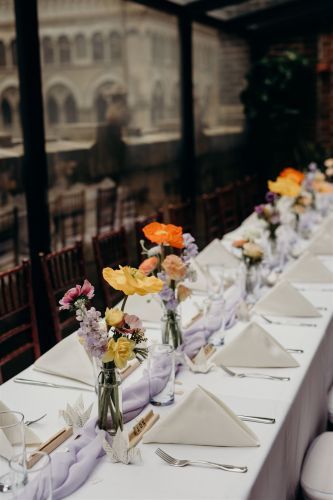 Adding small, mason jar, floral arrangements added the perfect floral touch to this banquet table. Photo by: Lauren Spinelli Photography